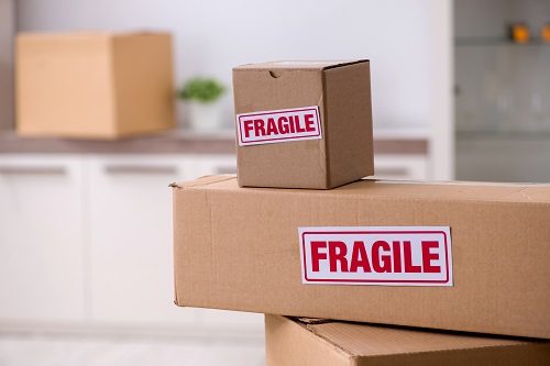 Man moving house and relocating with fragile items, storage moving